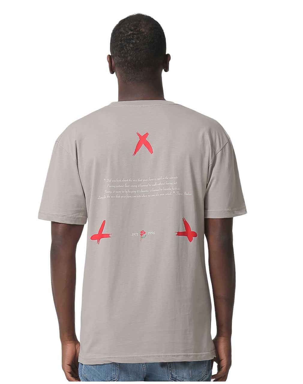 The back of a man's brown T-shirt with red crosses and text related to 2Pac.
